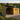 Wooden shed with a covered area for storing firewood, set against a scenic landscape.
