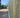 Wooden fence with a van and trees in the background