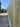 Wooden fence with a van and trees in the background
